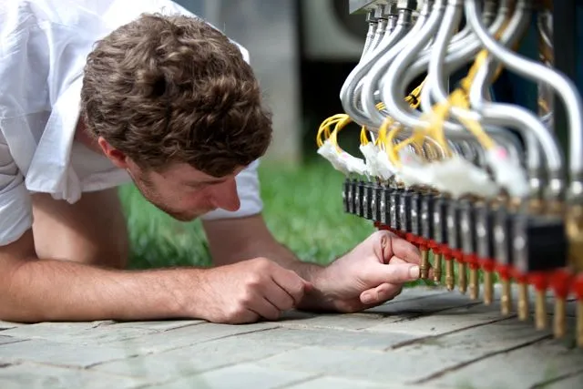 Nicholas Hanna adjusting the solenoid valves on his Water Calligraphy Device