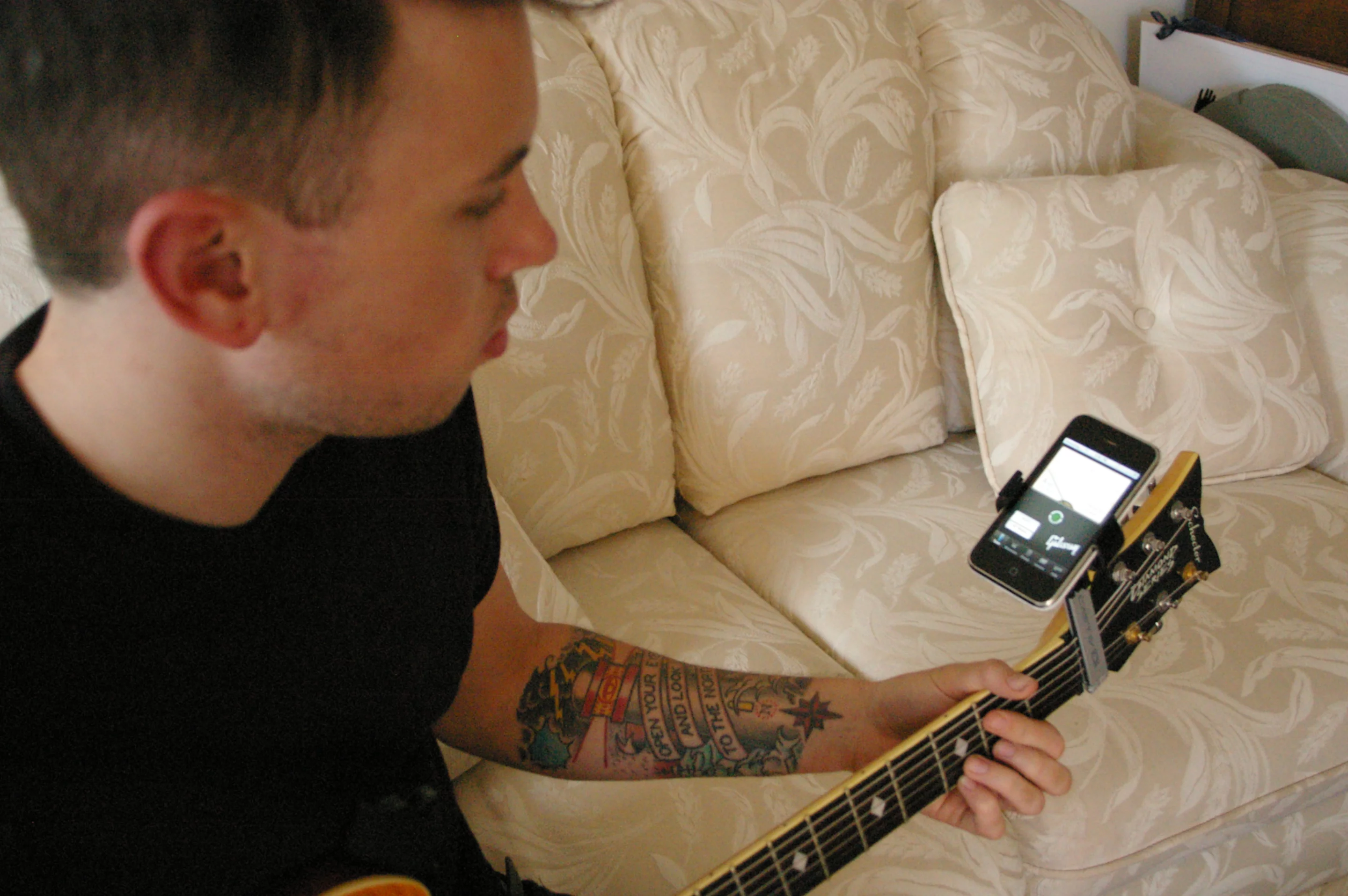 Ready to rock ... the Castiv Guitar Sidekick holds the iPhone while tuning the guitar using the Gibson app