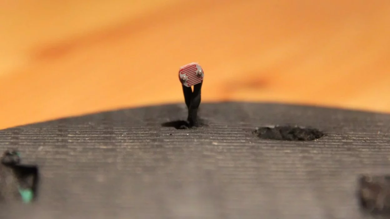 A light sensor is used to control the raising and lowering of the digital hi-hat