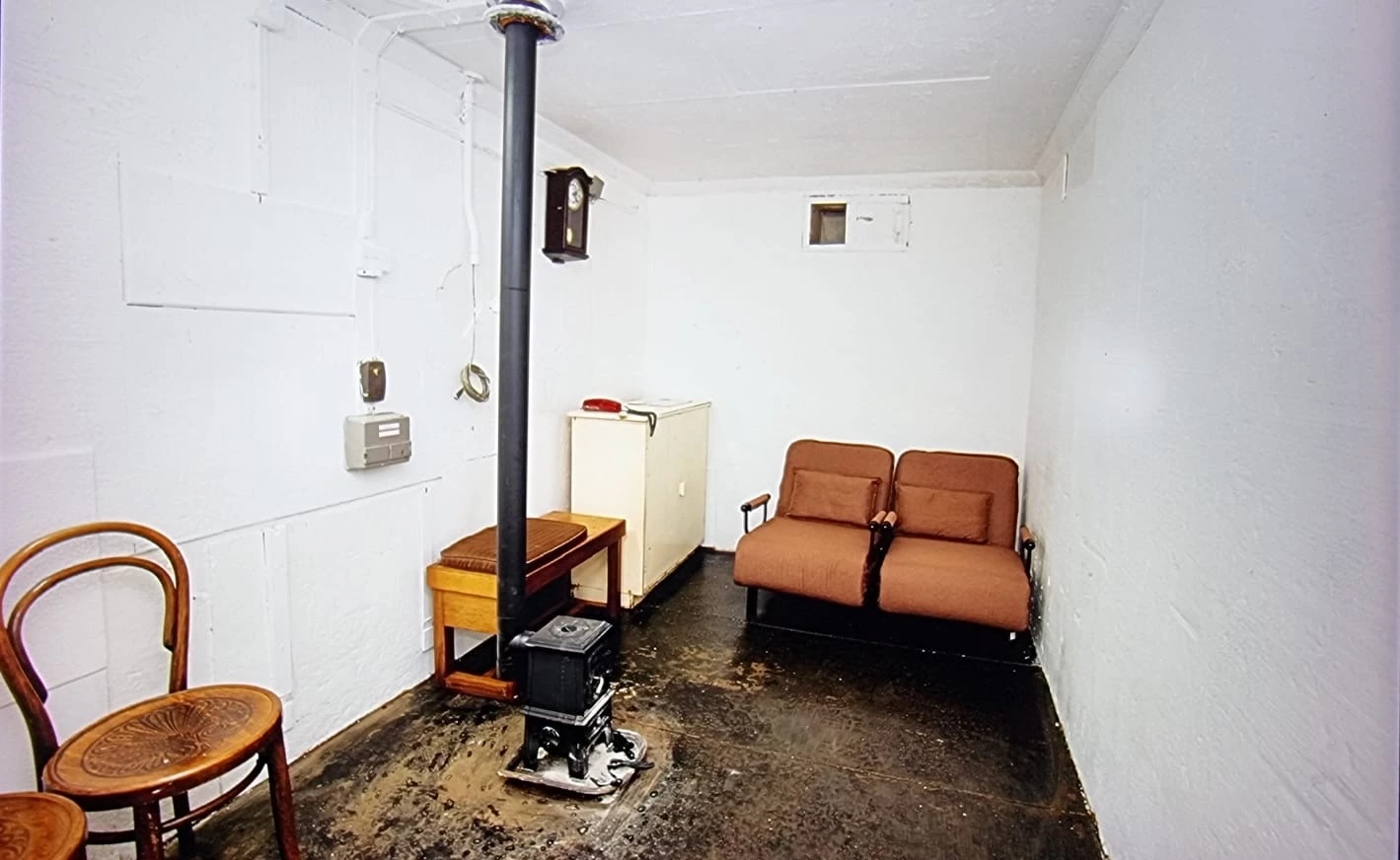The ROC Nuclear Bunker's interior looks quite snug and includes some seating and a small wood-burning stove