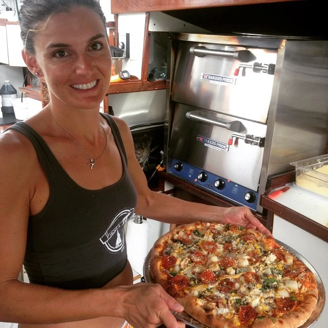 The couple customized and hand built the boat's kitchen to accommodate commercial pizza ovens, fridges, bench space and storage