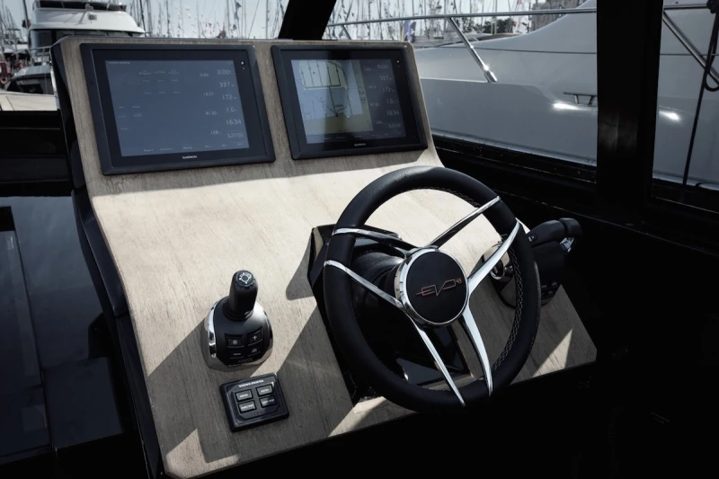 The helm station includes a curved teak panel