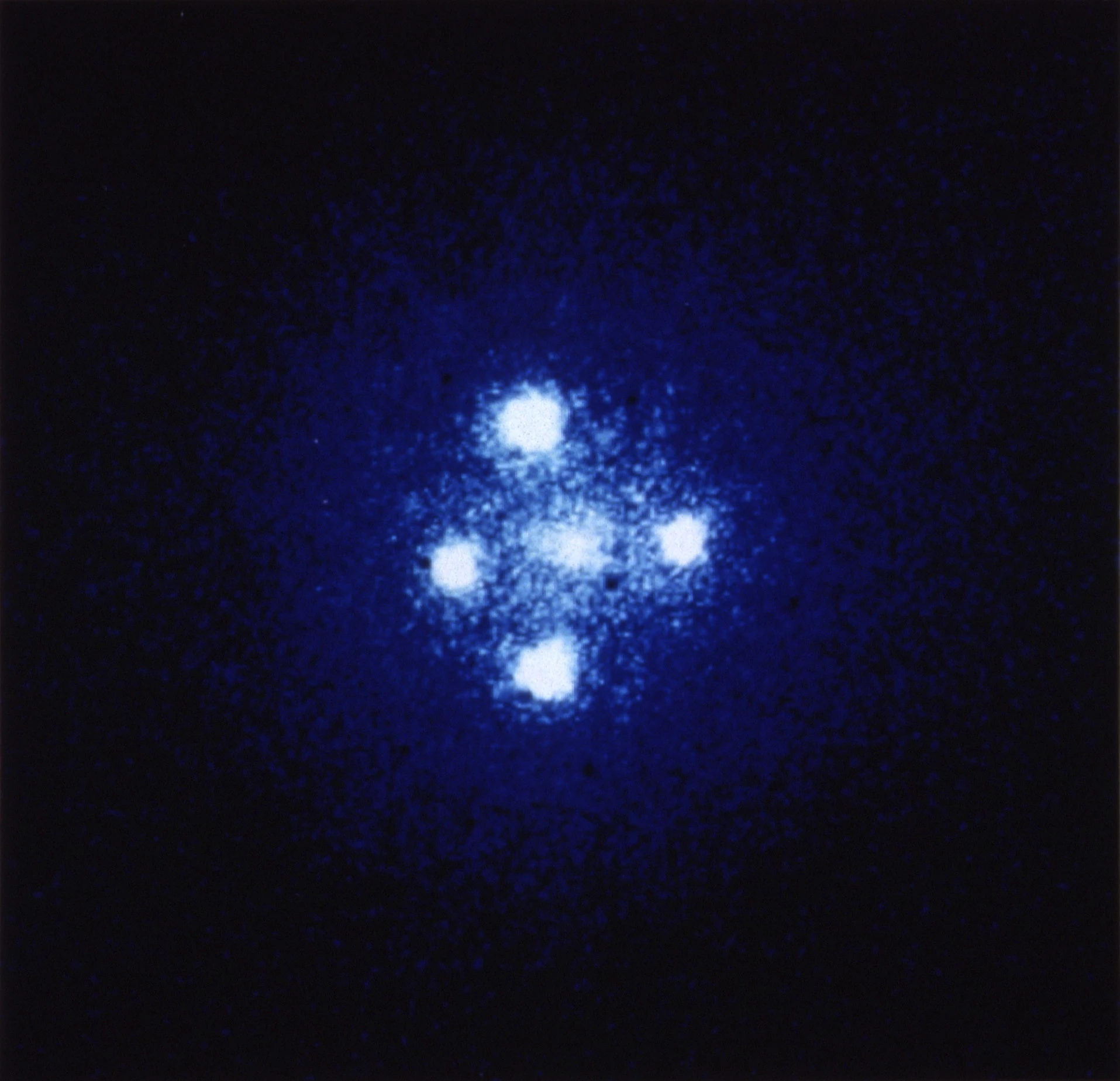 An Einstein Cross, where a gravitational lens creates multiple images of a more distant quasar