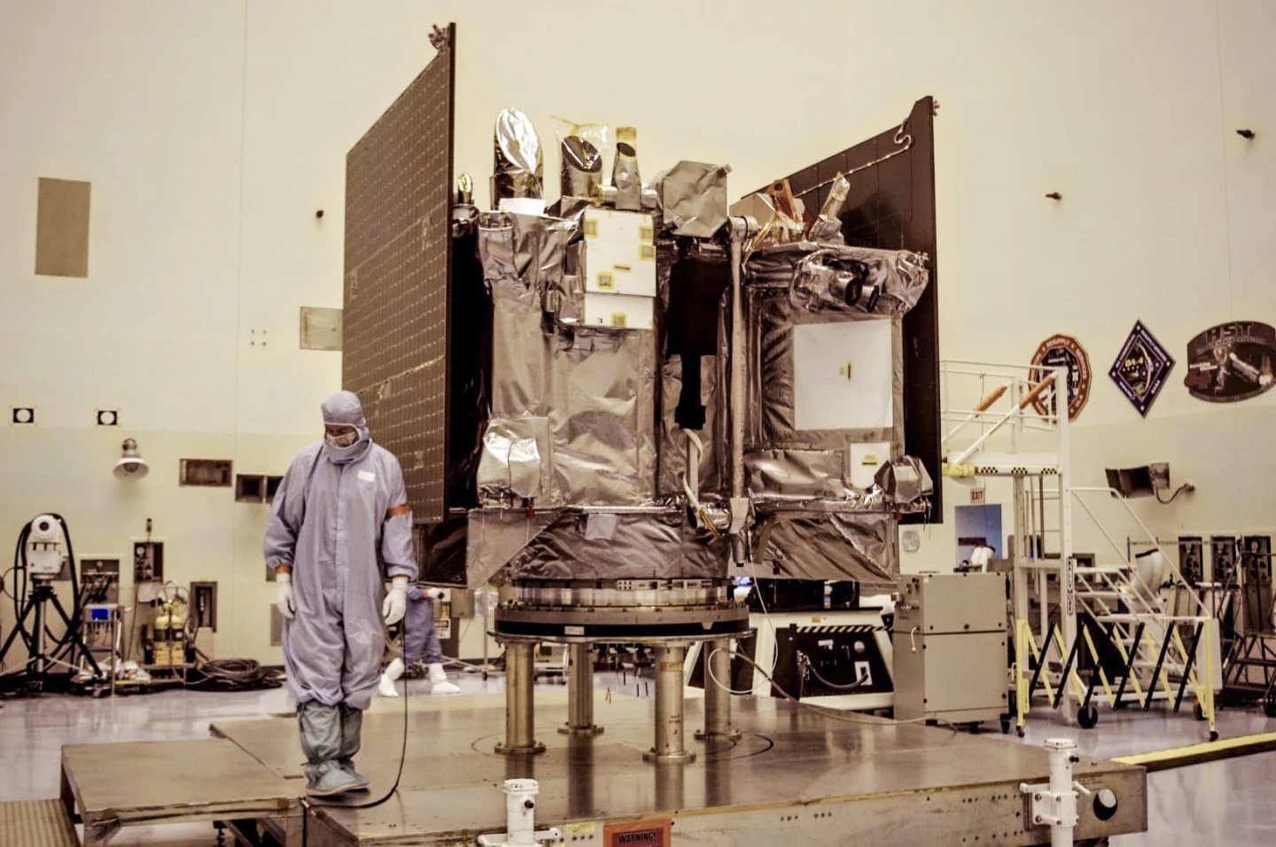 The black-wrapped portion of the satellite is its TAGSAM arm, which stands for touch-and-go sample acquisition mechanism