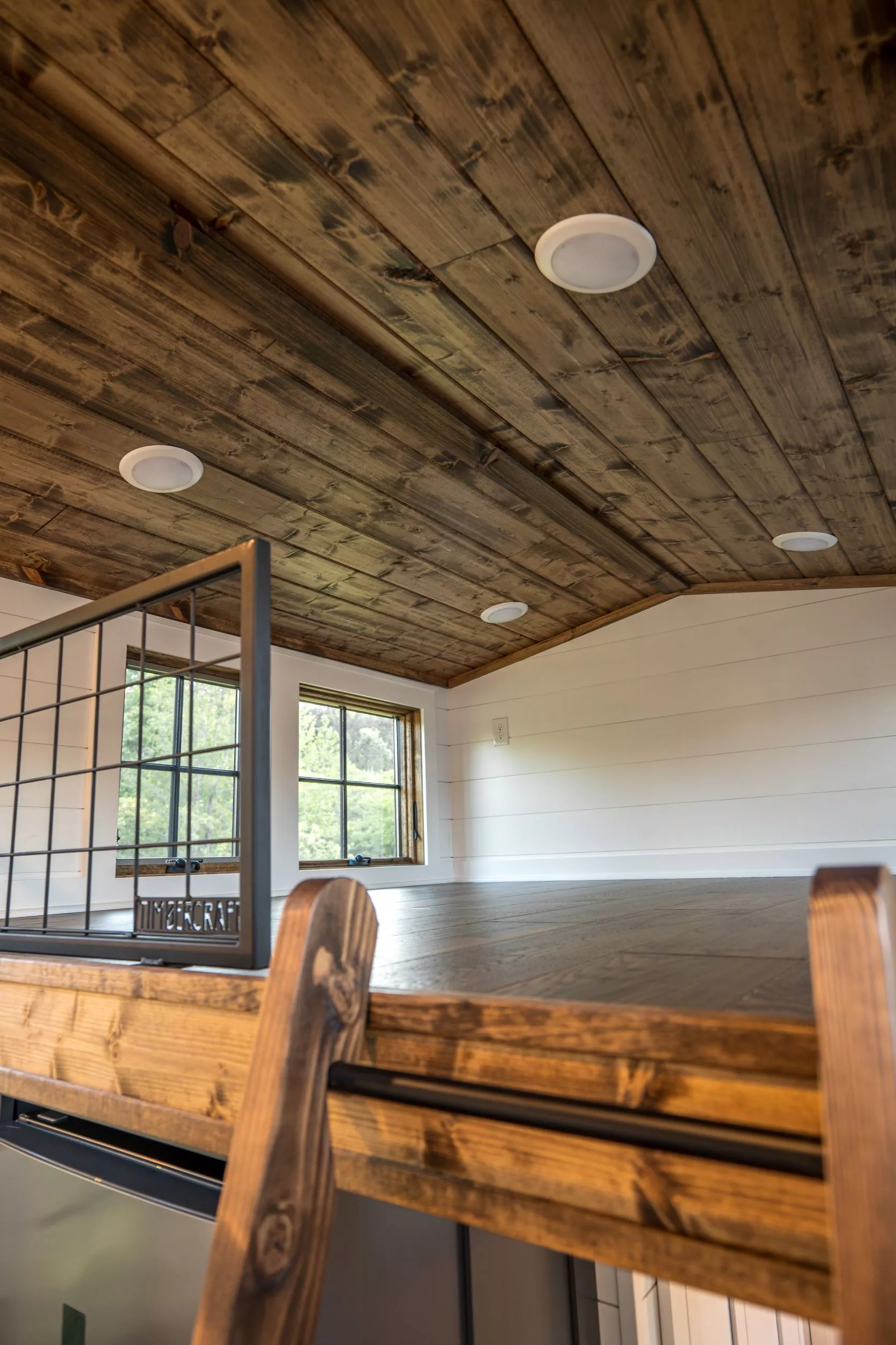 The Teton's secondary bedroom is a typical tiny house loft-style bedroom with a low ceiling