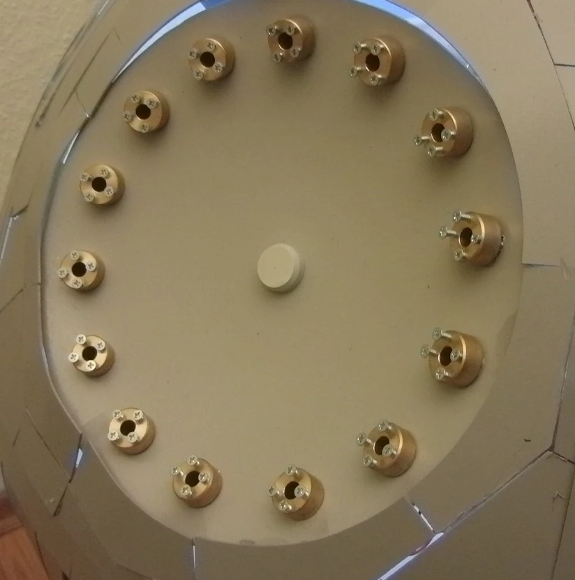 The hole in the sphere is taken up by the circular reflector from a halogen floor lamp, around the edge of which are mounted 14 6-watt lasers