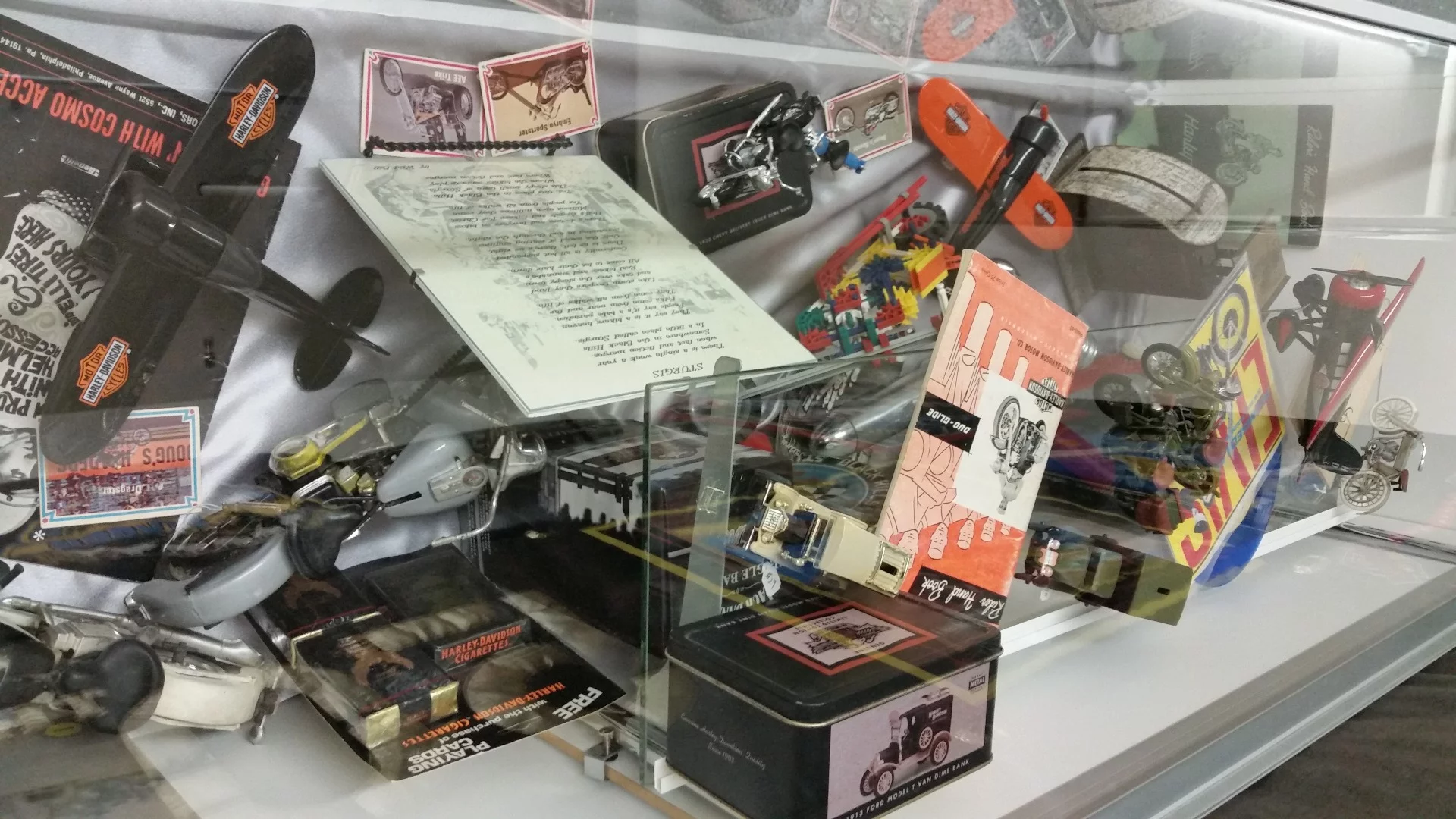 Several glass enclosed displays show some of the paraphernalia that pays tribute to bygone days