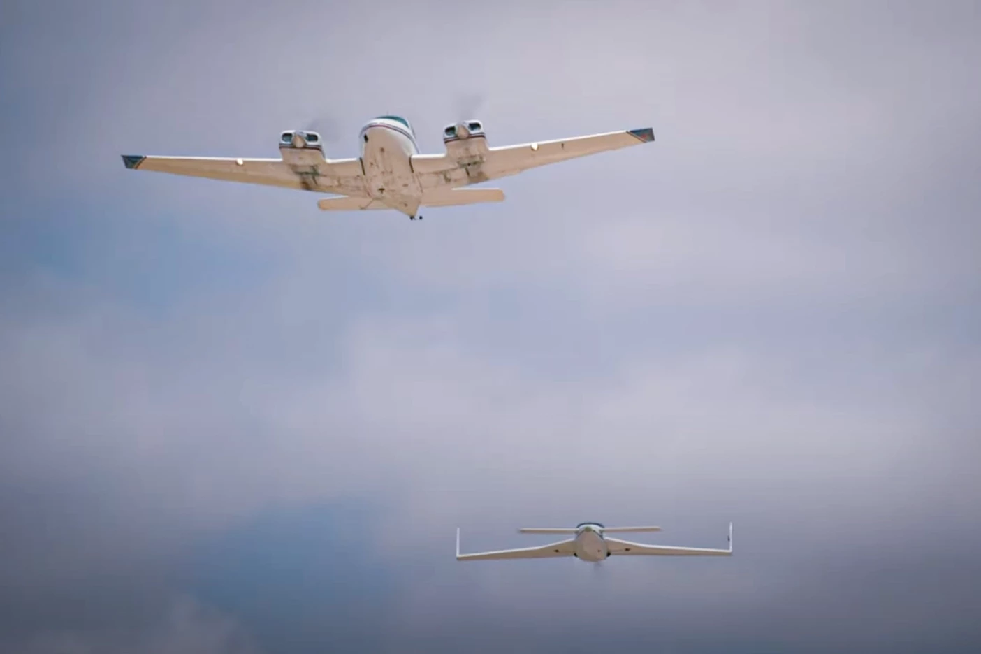Aerolane's prototype cargo gliders both still have engines and propellers installed at this point, but have a custom autopilot system designed to surf the lead plane's wake vortex for maximum efficiency