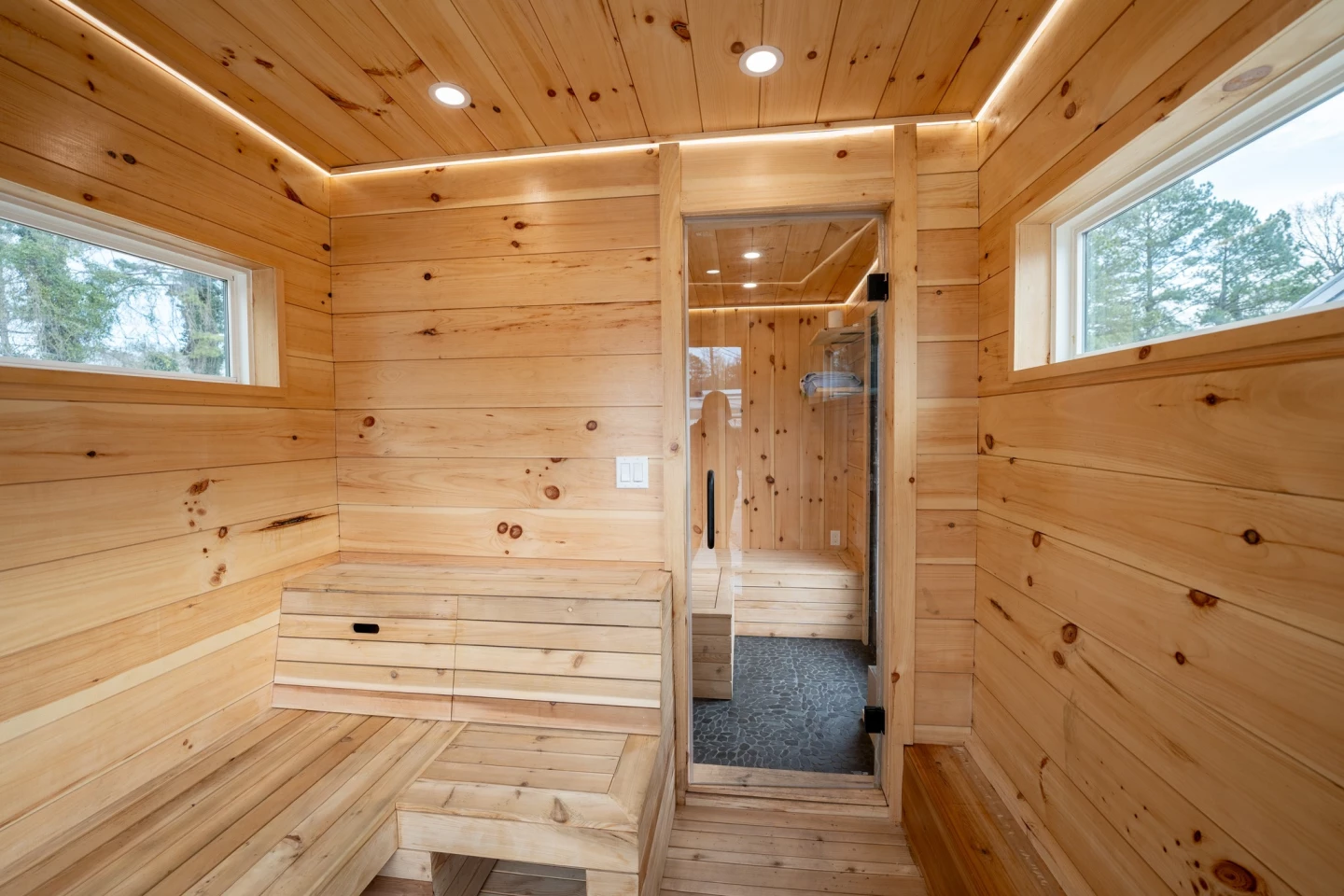 The tiny house sauna's actual sauna area is waterproof and includes a hose for cleaning it after use