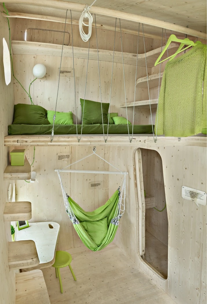 The cozy unit features a dining area, kitchen, study desk, a swinging lounge, elevated sleeping quarters, bathroom and a small outdoor patio