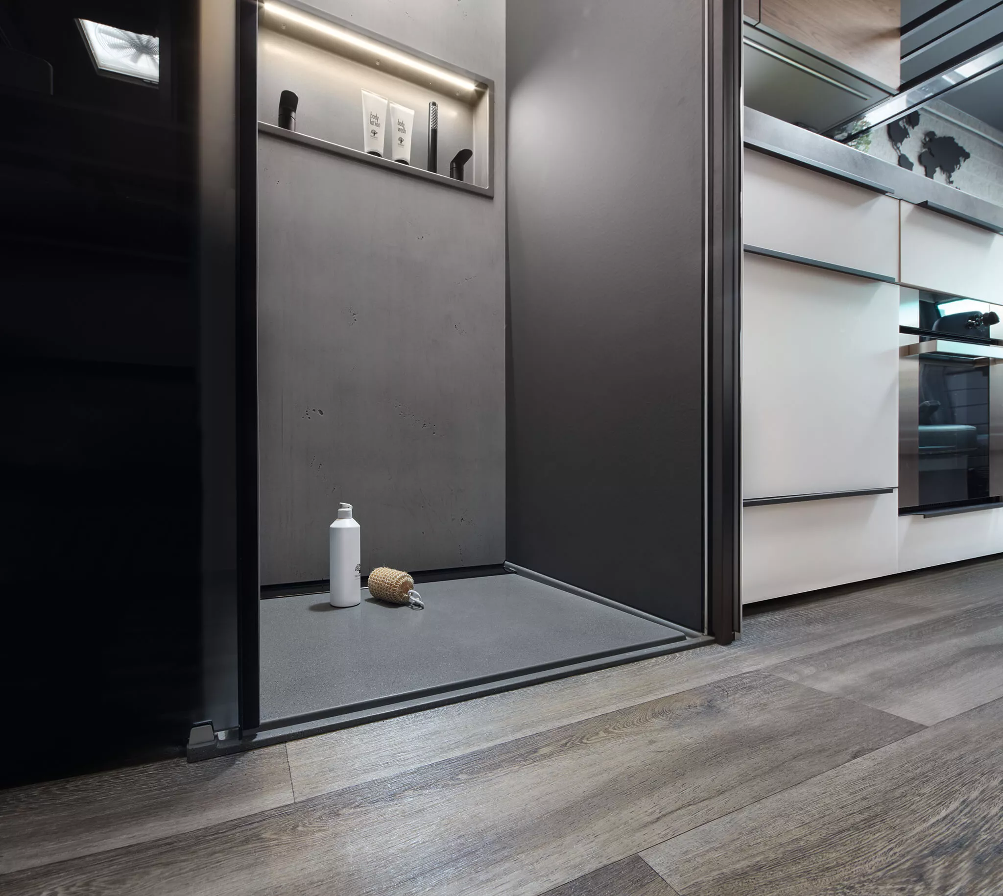 Thanks to its size, the Flair does not need a transforming wet/dry bath like Niesmann's smaller iSmove, but it does share the same style of concrete-effect shower design