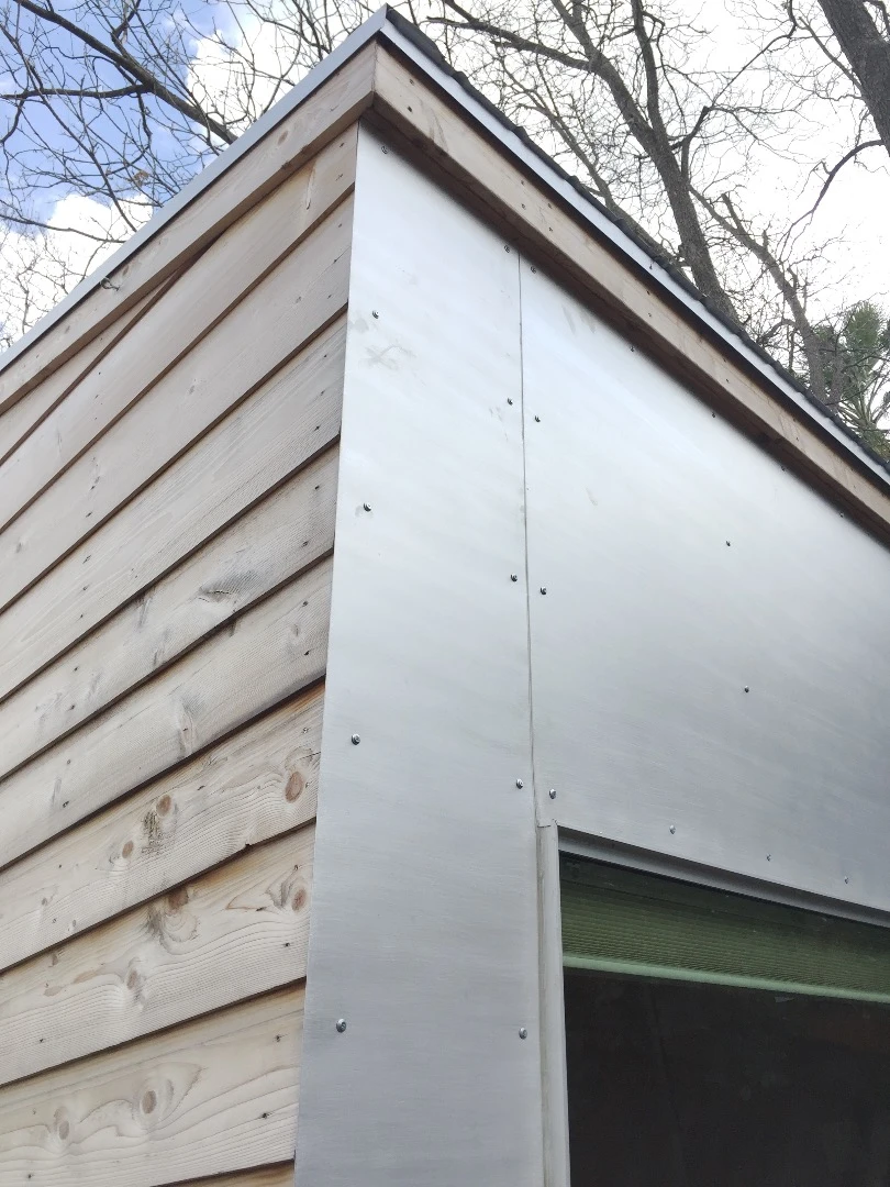 The tiny house features cedar and aluminum siding