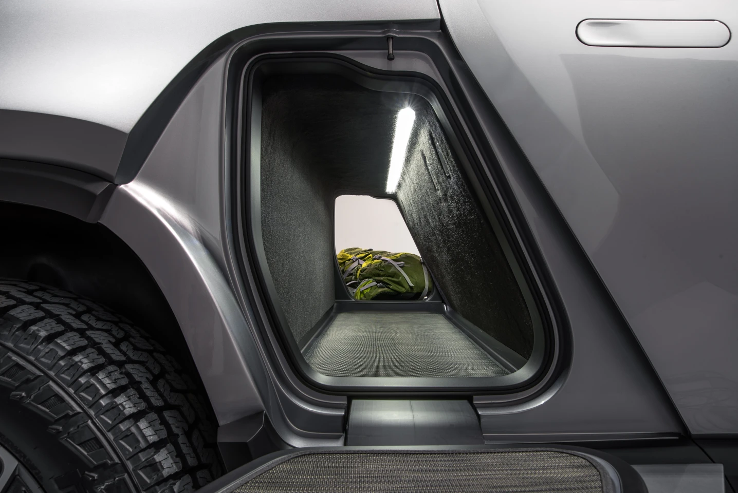 Rivian gives the R1T a storage tunnel that passes cleanly from one side to the other