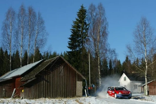 Sebastien Loeb bursts out of the forest in the Swedish Rally