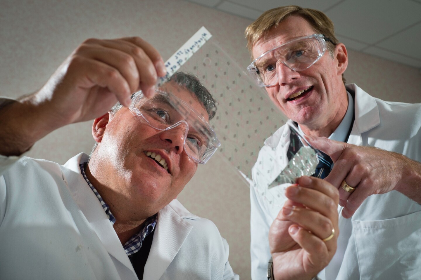 University of Warwick research chemist Prof. David Haddleton (left) and Medherant CEO Nigel Davis, with a sheet of the patch material