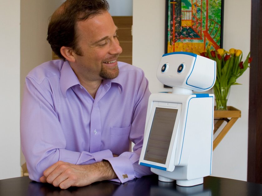 Dr. Cory Kidd, founder of Intuitive Automata, poses with his robotic weight loss coach Autom