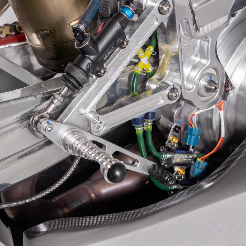 Adjustable swingarm pivots and exposed cooling lines