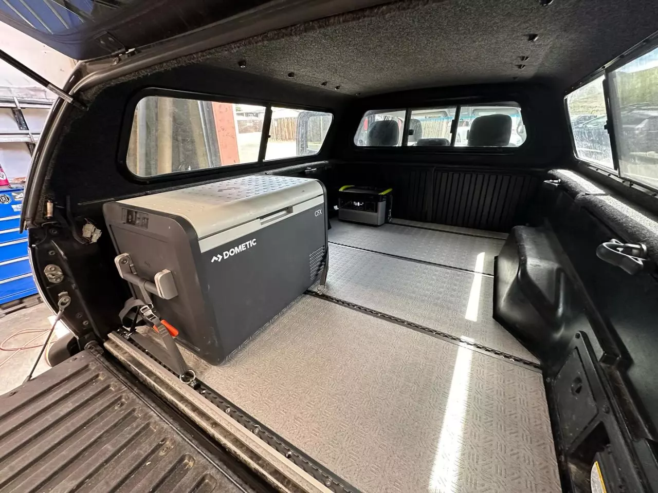 Securing down a fridge is one natural use for the Launch Pad flooring, whether that means a slide or simply strapping it to L-track tie-down points