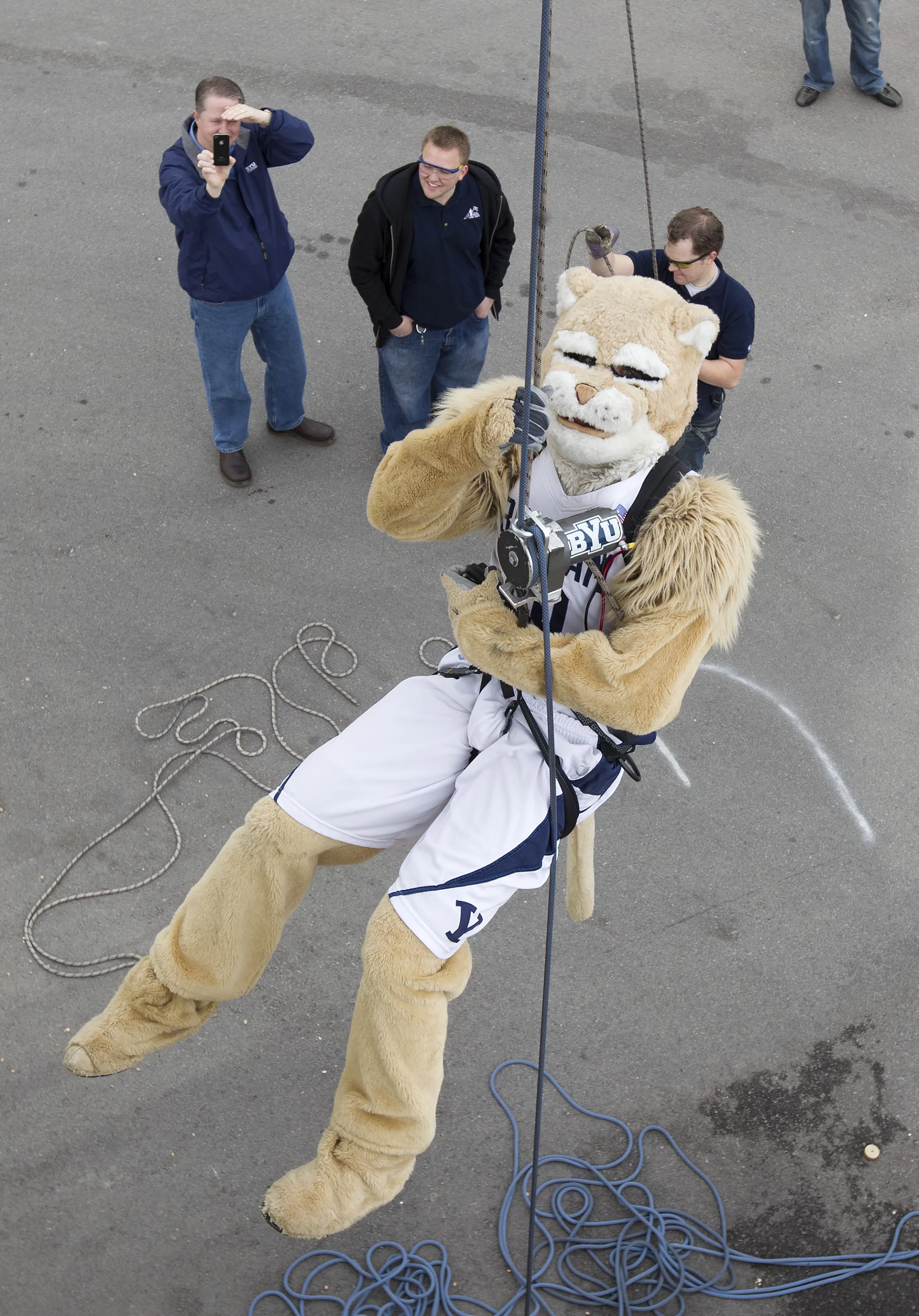 BYU mascot Cosmo tries his hand at using the winch device, which pulls a person up with the push of a button