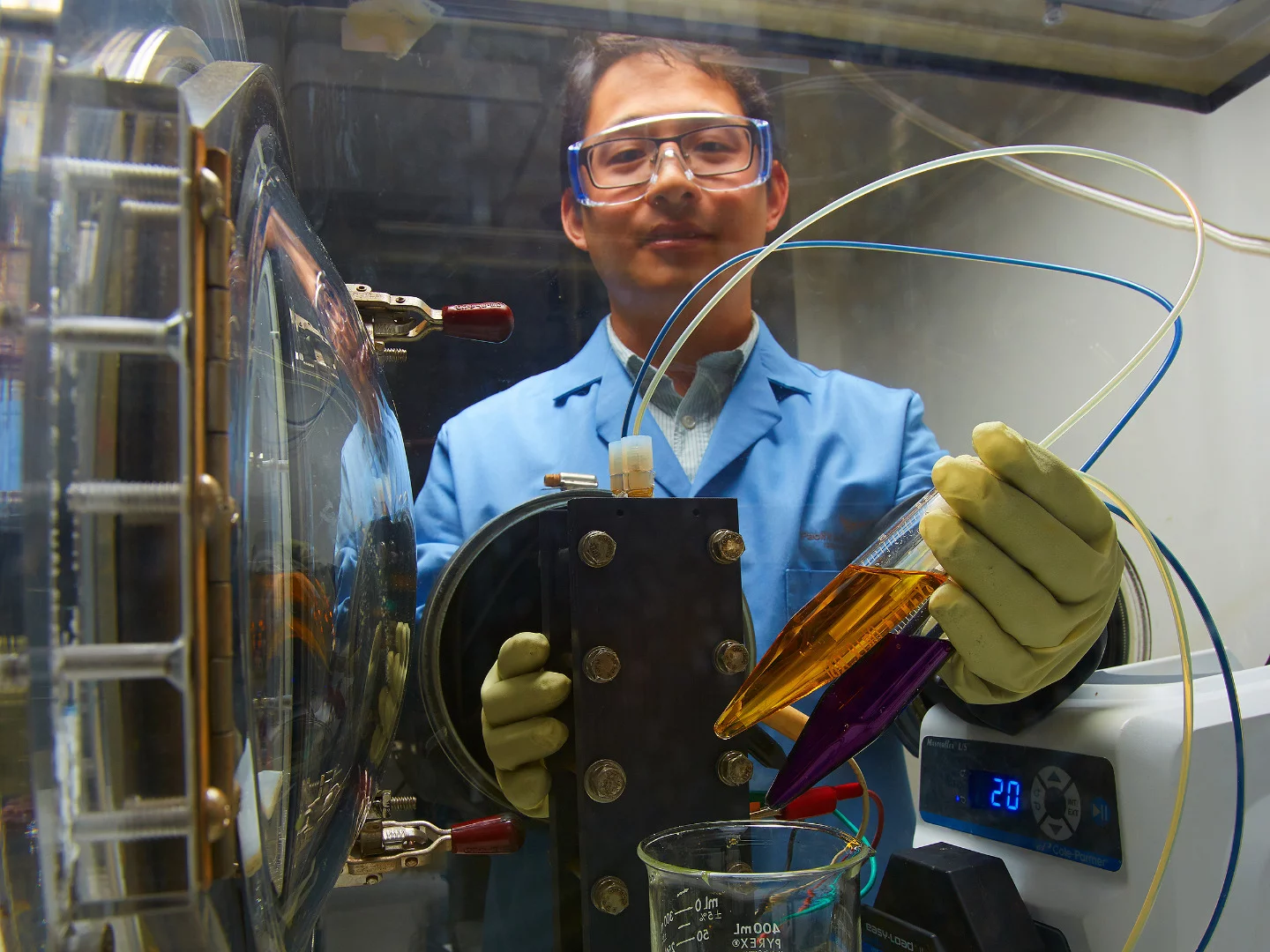 A new flow battery technology is expected to cost substantially less and be better for the environment thanks to its organic water-based electrolytes, as seen here in a small demonstration by PNNL researcher Xiaoliang Wei
