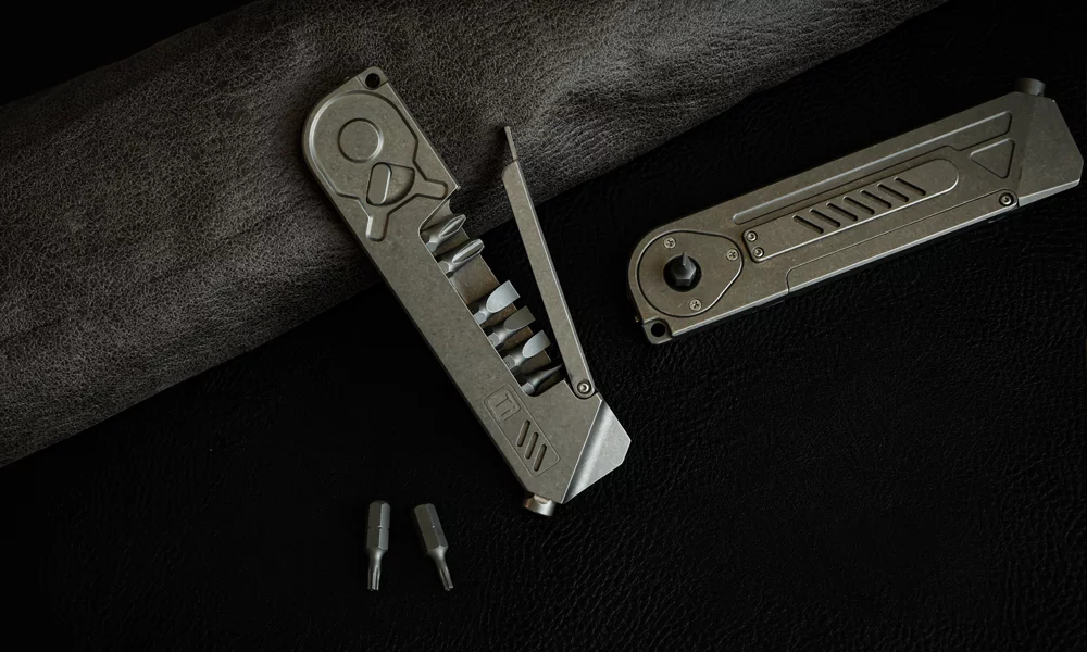 The titanium tool features a ratchet screwdriver and bit driver