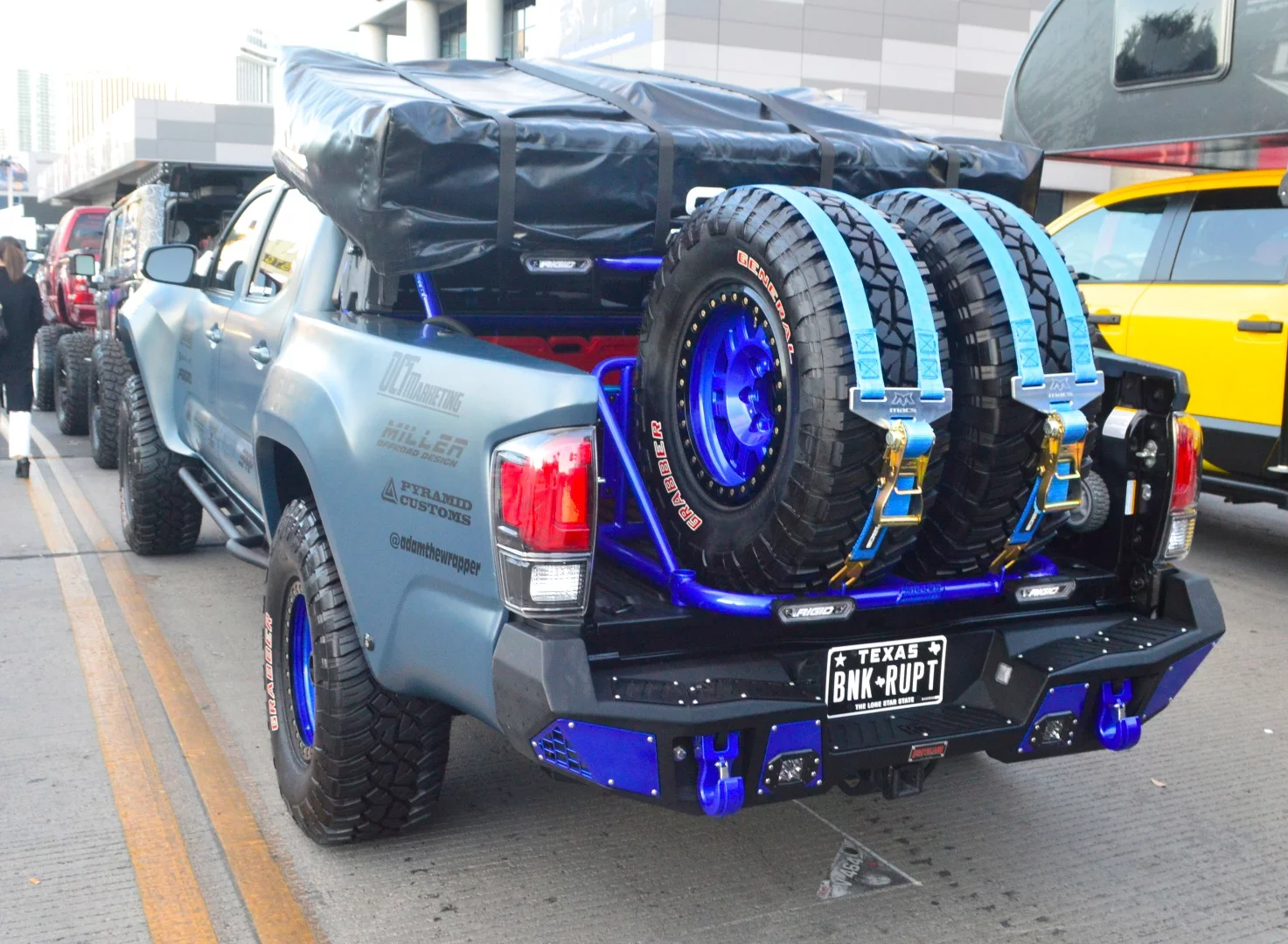 Pickup truck holding a roof-top tent and spare tires