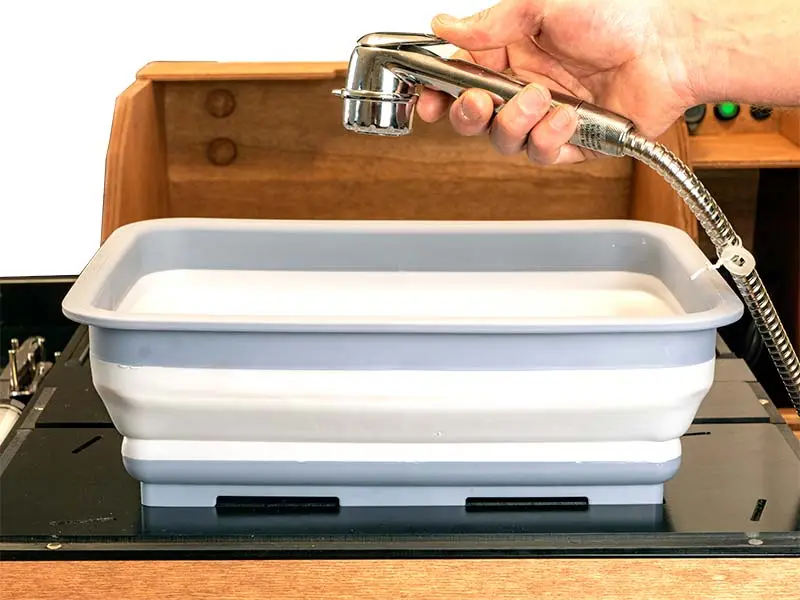 The battery powers a water pump for the sink sprayer