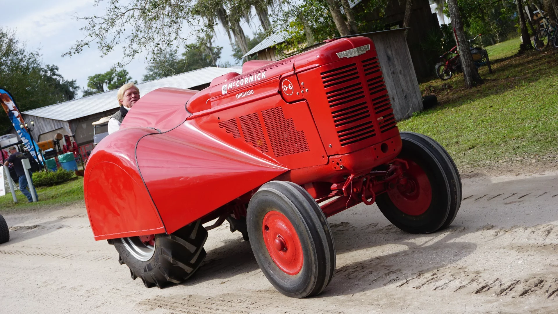 This exotic looking machine is a McCormick Orchard Tractor. Extra slim with exotic looking bodywork designed to travel thru orchard isles, orchard tractors are prized by collectors