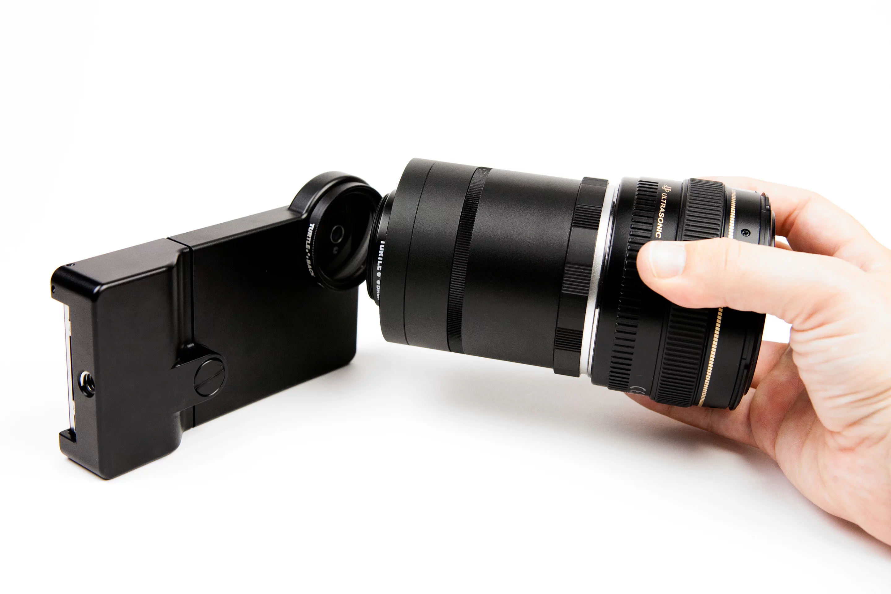 The iPhone SLR mount will allow to use a Canon or Nikon telephoto, wide-angle, macro, fish-eye (and so on) SLR lens with your iPhone's camera (Photo: Photojojo)