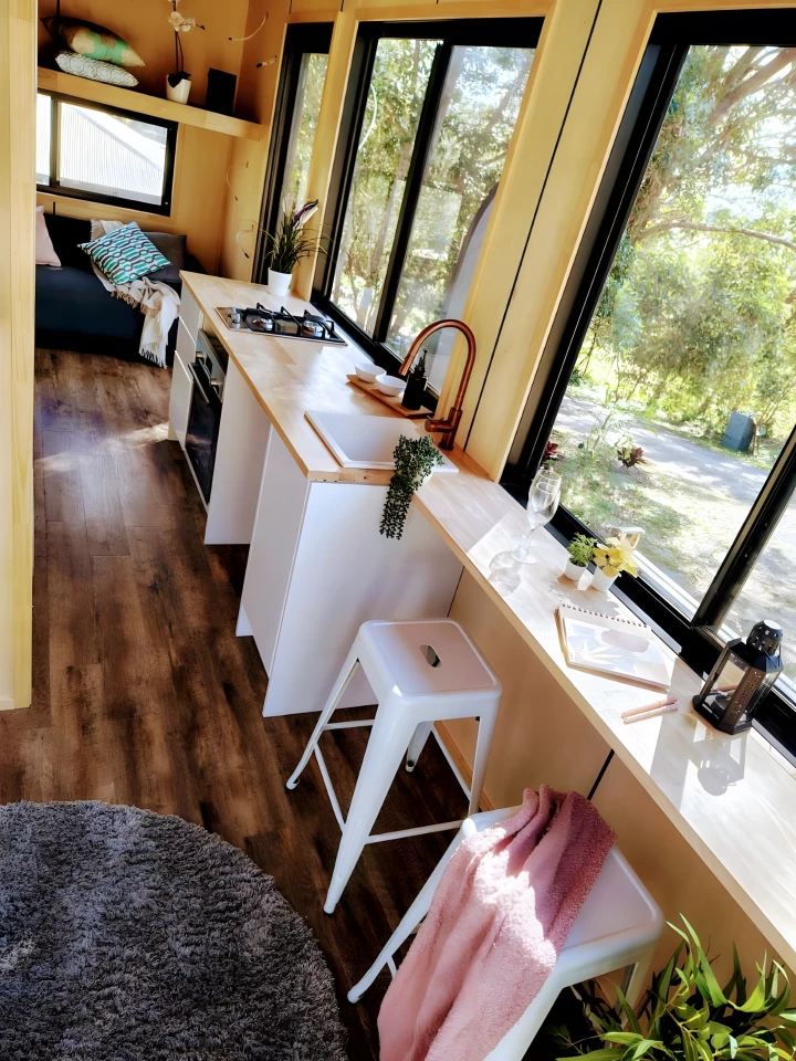 The Escapada includes a living room with a sofa and a storage loft that can optionally be turned into an additional sleeping area
