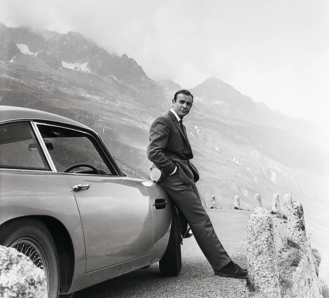 Sean Connery and the famous "Birch Silver" Aston Martin DB5 during the filming of "Goldfinger"