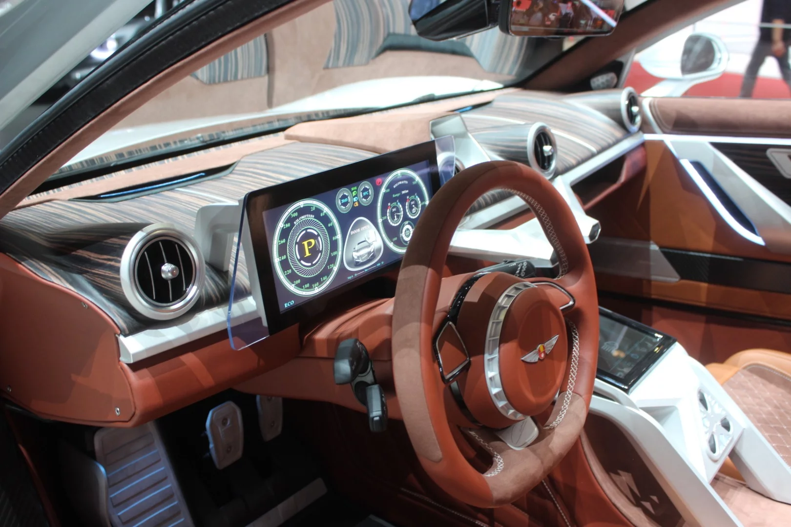 Hispano Suiza's interior truly exemplifies retro-modern, combining hand-sewn upholstery, classic equipment like toggle switchgear and an analog clock face, materials like leather, Alcantara and wood veneers, and carefully arranged digital display tech