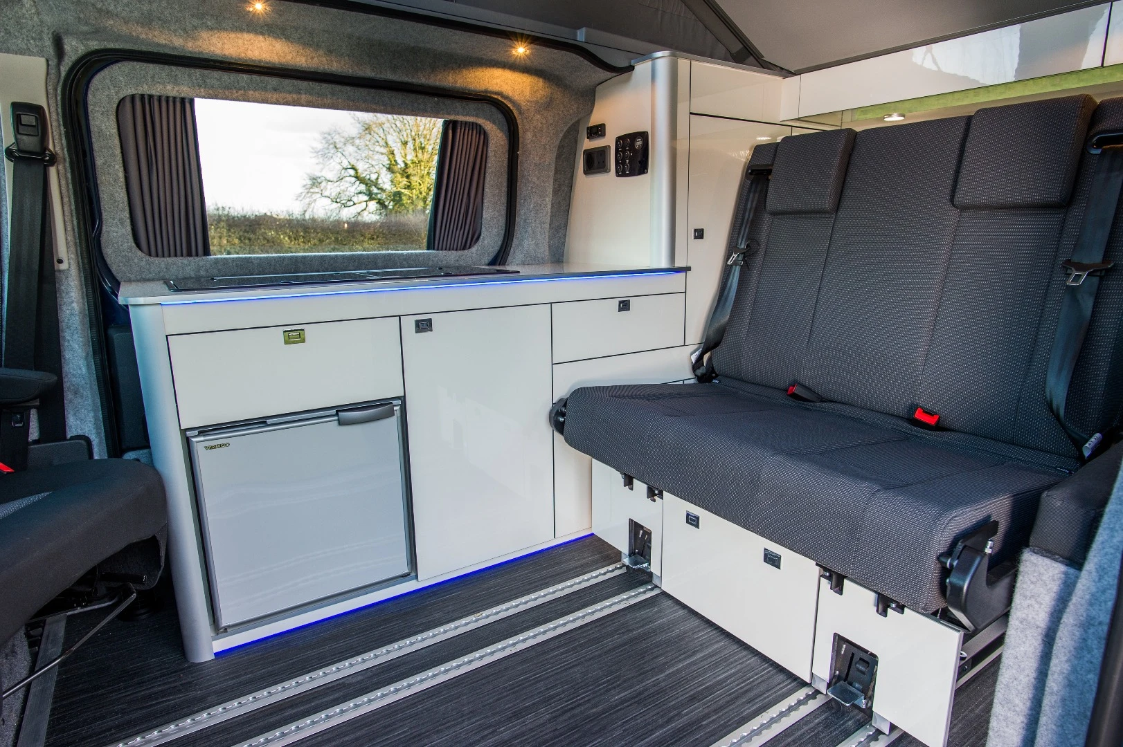 The interior uses floor rails for versatile space management