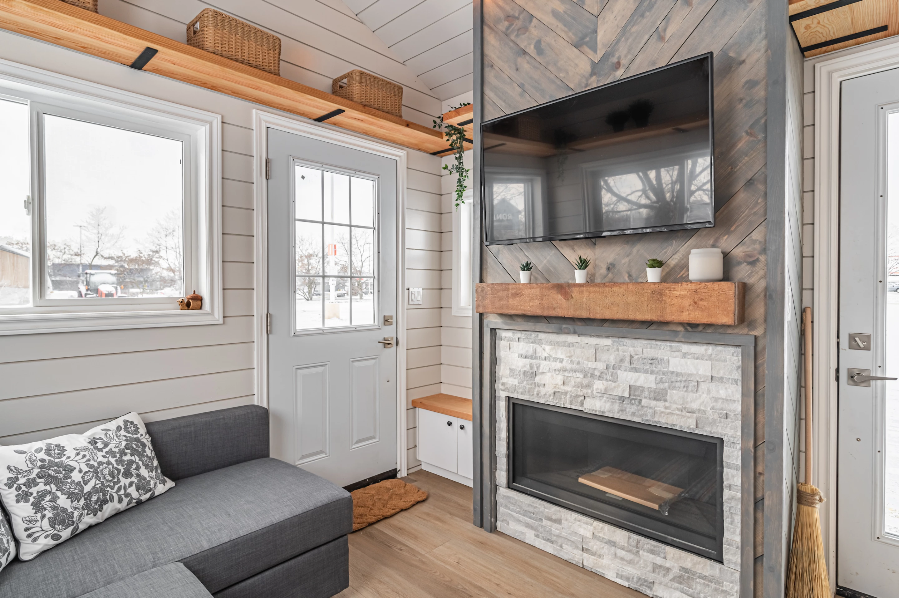 The Paddock Paradise's living room includes a large L-shaped sofa and a fireplace