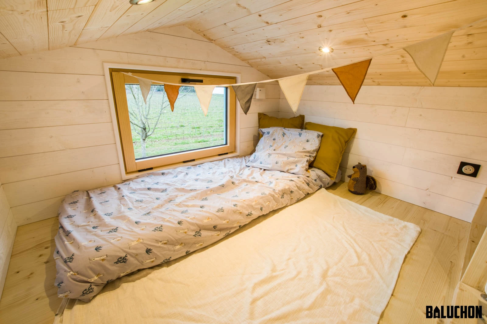 The Tiny house Kalzennig's secondary bedroom includes a single bed, though has space for a double