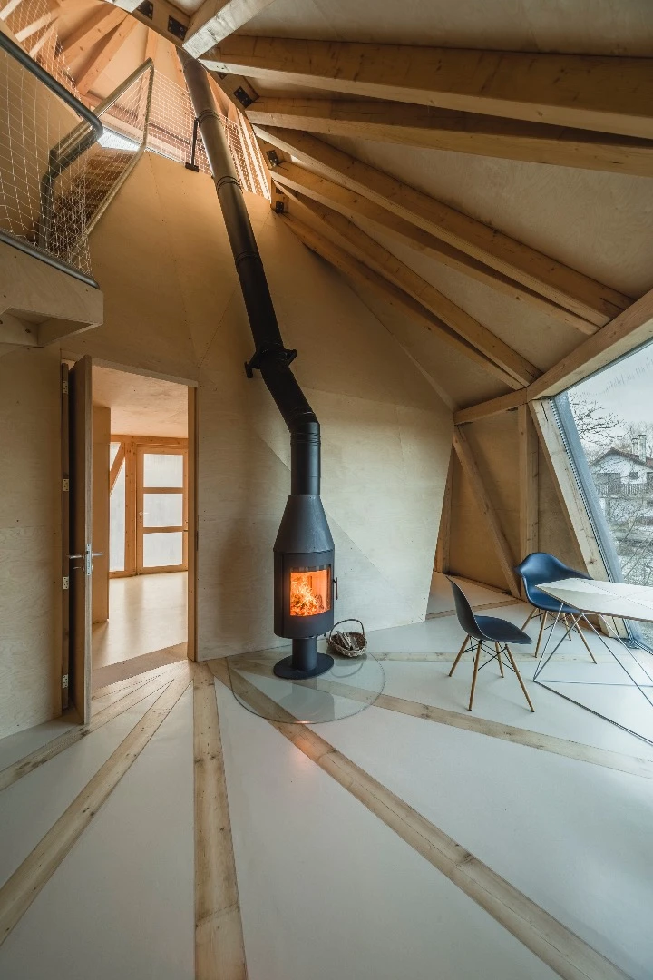 Heat for the House in the Orchard is produced by a wood-burning stove