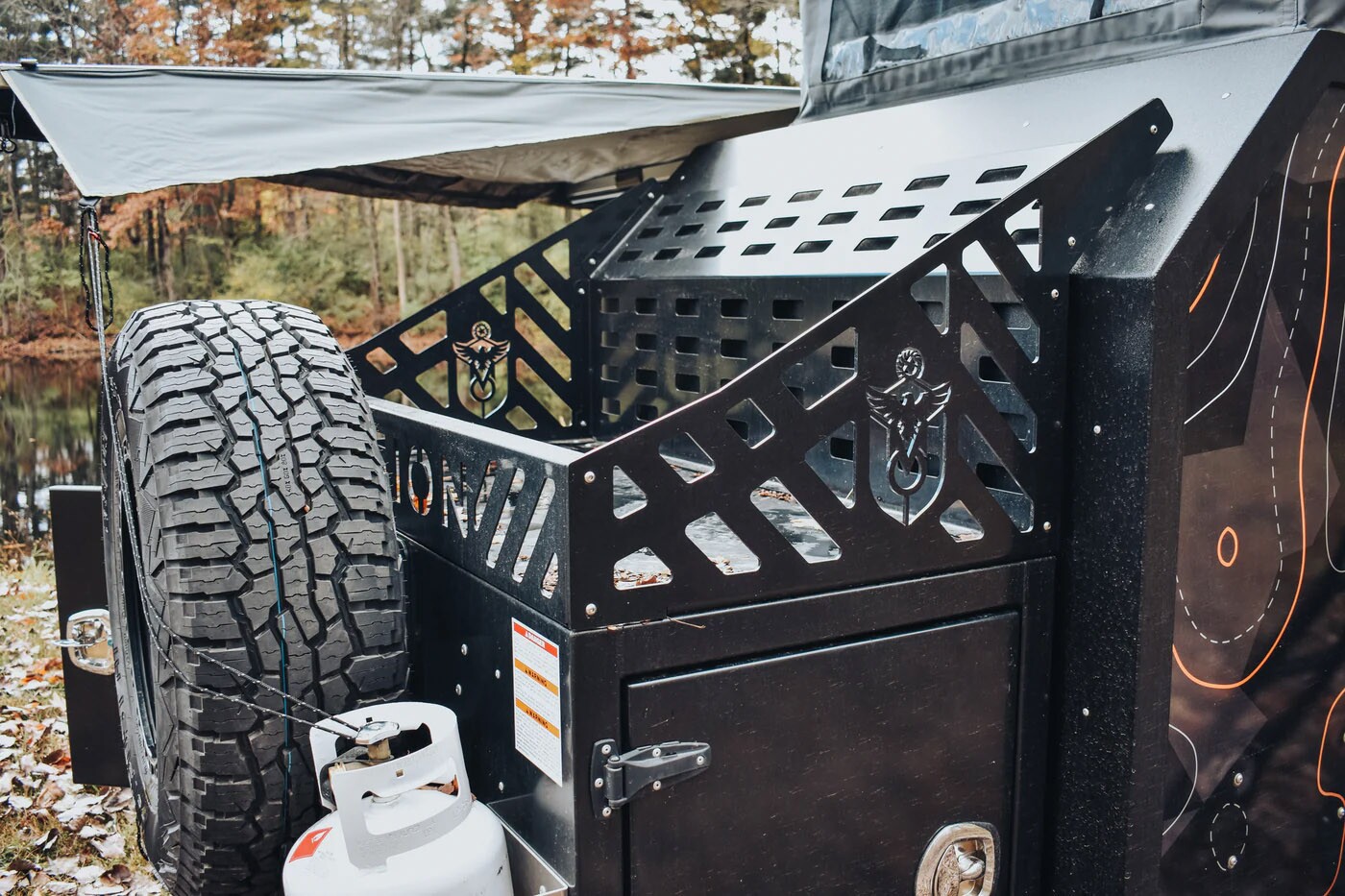 The front of the trailer has room for a spare tire and rim, two propane tanks, and a large storage rack