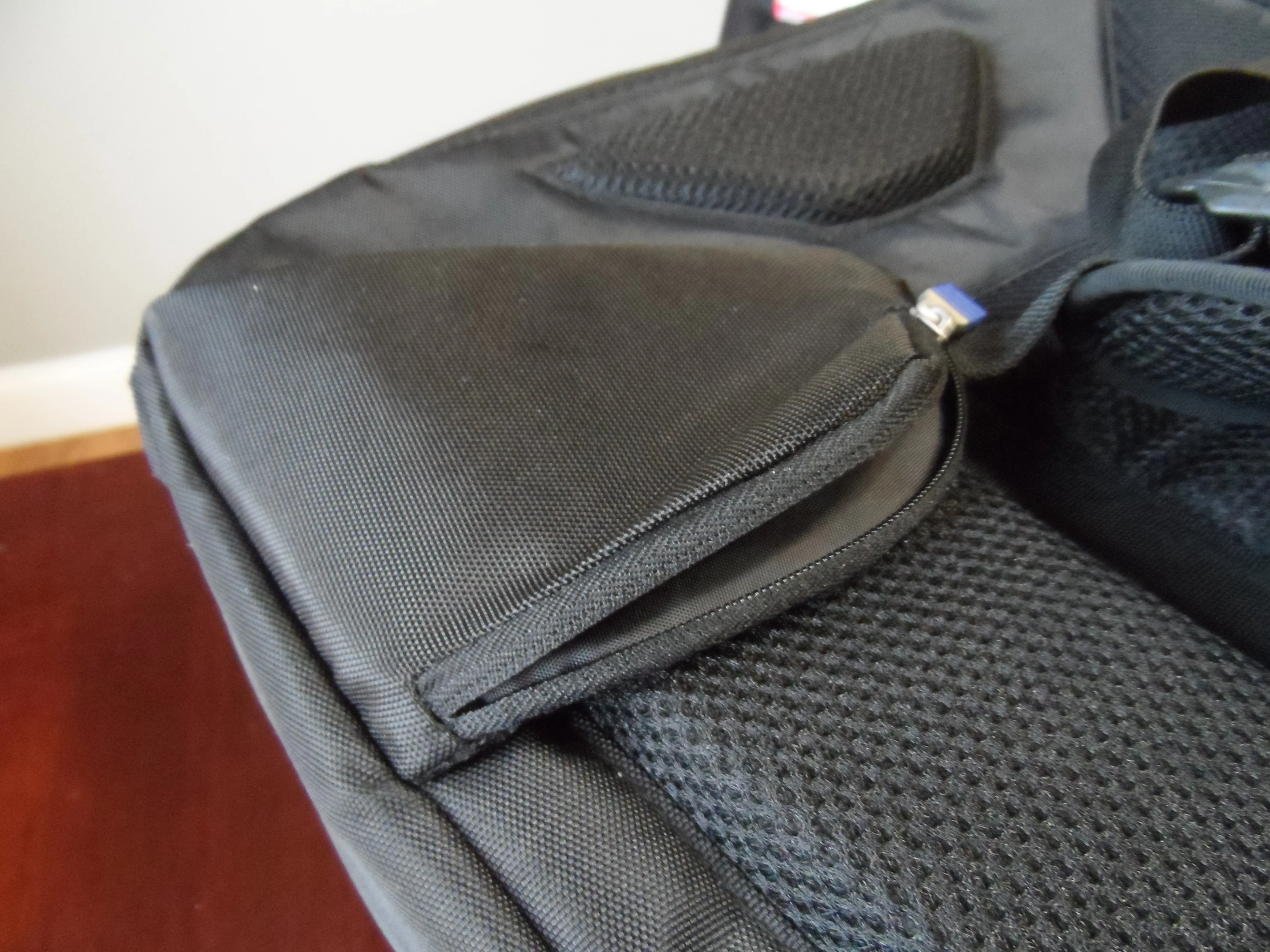 The headphone pocket is located on the end of the shoulder strap for easy access