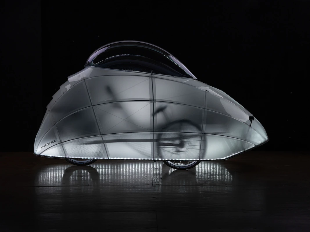 The bottom part of the covering is lit with colored LEDs, while a transparent dome at the top lets the rider see where they're going