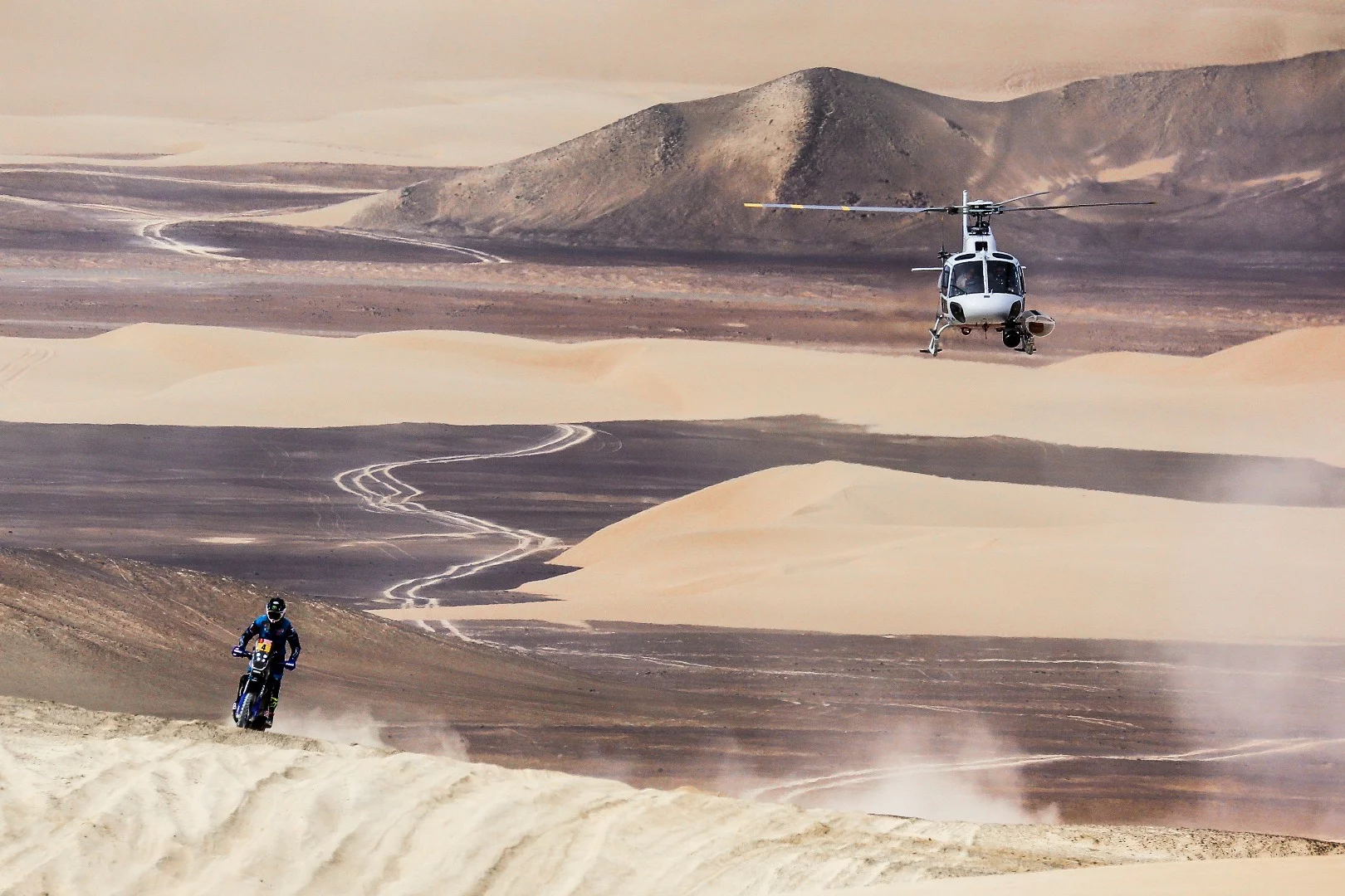 Aerial footage is always a highlight of the Dakar. Here, a chopper follows Van Beveren's Yamaha across the desert landcsape