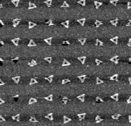 Individual triangular DNA origami adhering to a template with properly sized triangular features