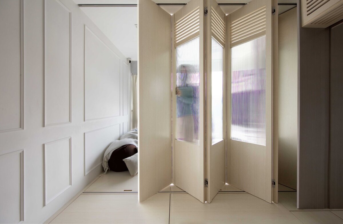 The living room can be closed off from the open kitchen area with lightweight sliding bi-folding doors