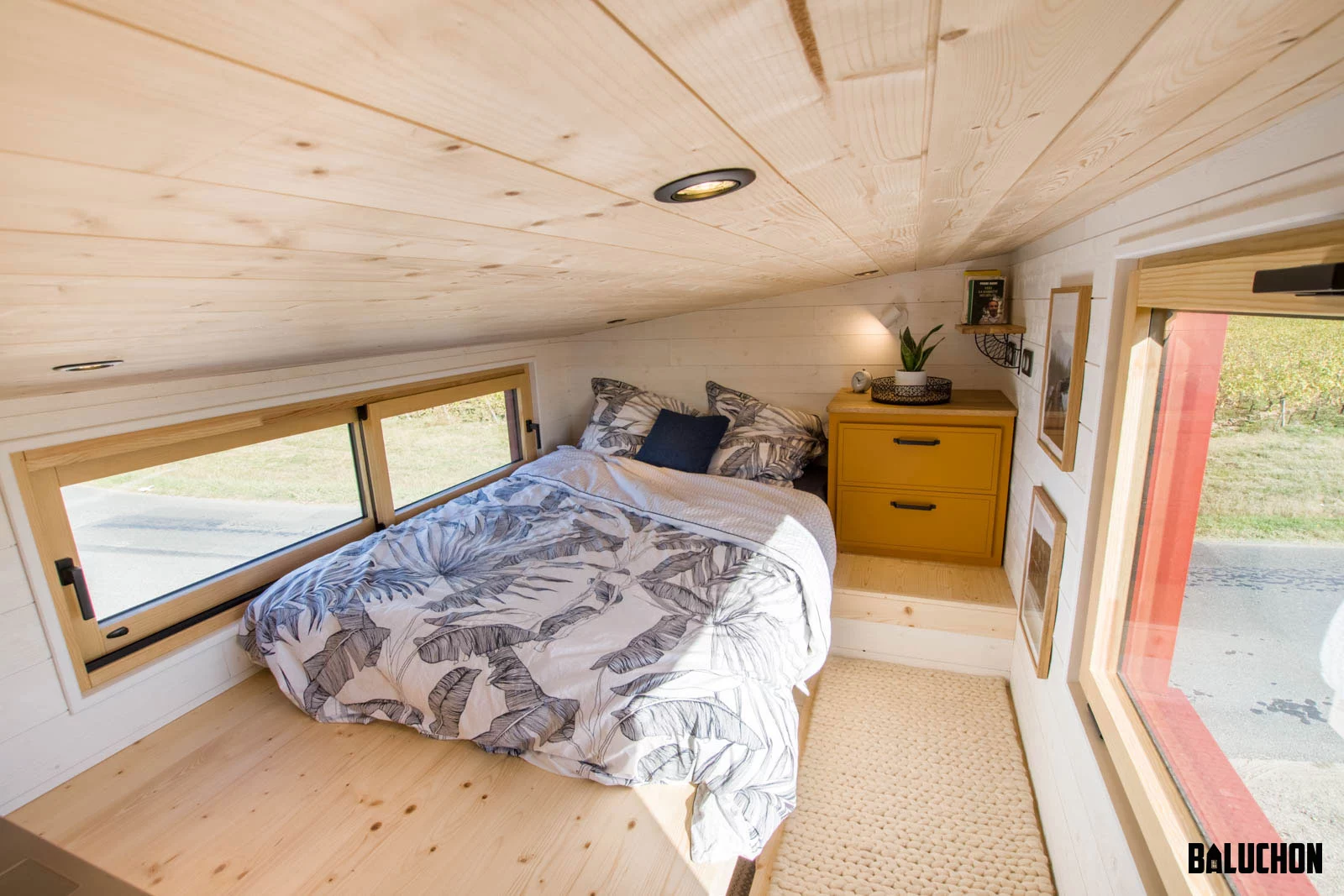 The Golden Hour's bedroom includes a double bed and is topped by a sloping wooden ceiling
