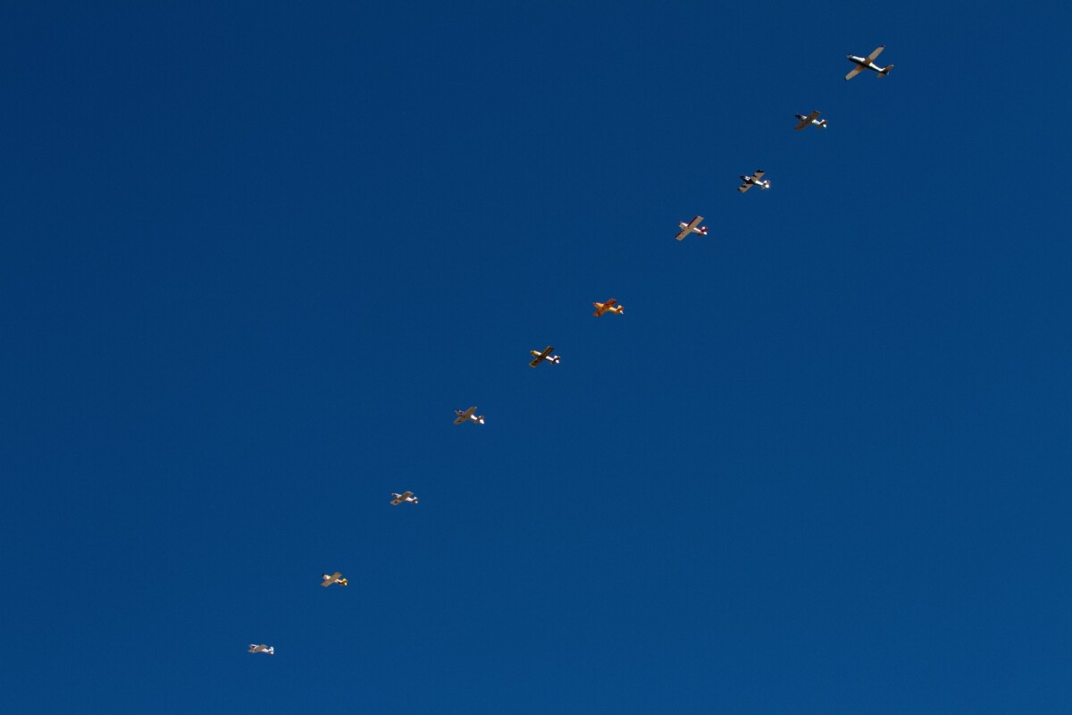 Classes that don't start gridded up on the runway line up in the air. The jet on the right is the pace plane, and the race starts when it pulls back and flies up