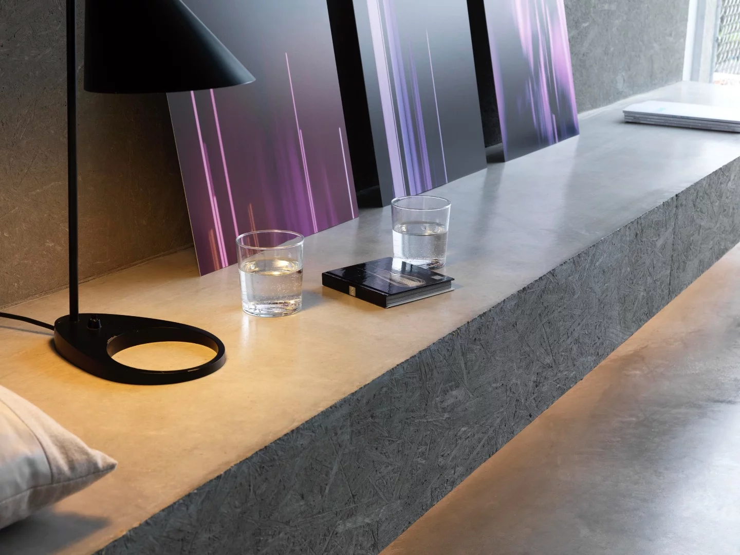 Affordable Housing Langgrütstrasse features simple furniture, including built-in shelving and benches
