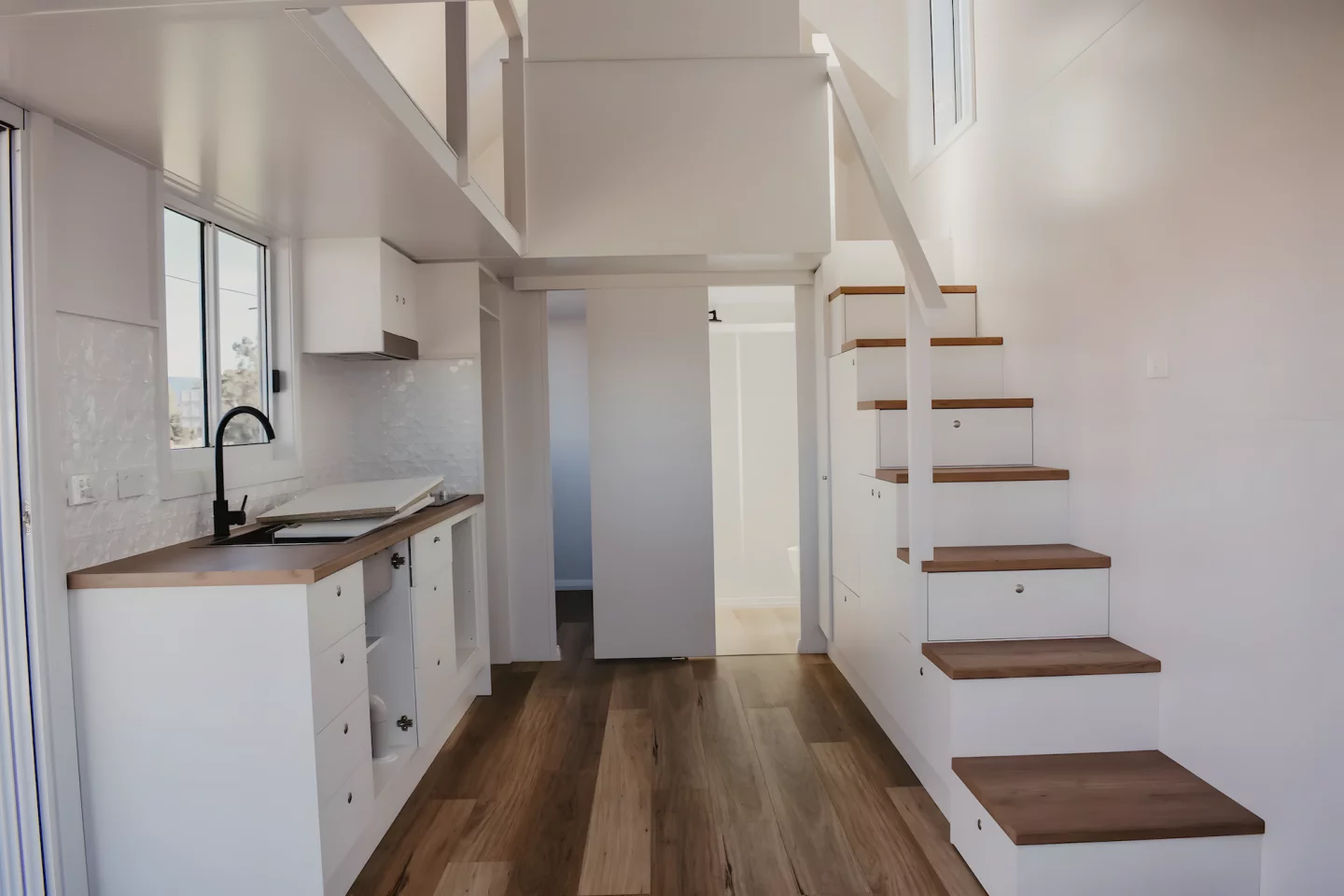 The Joely's upstairs bedrooms are reached by a storage-integrated staircase