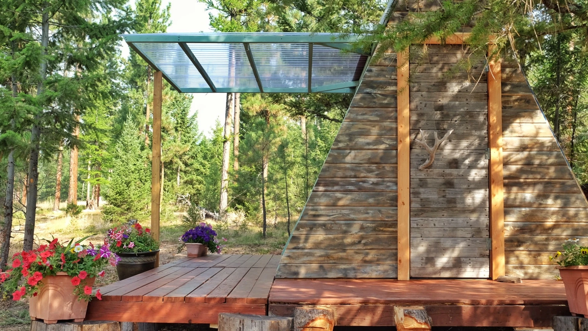 A section of wall lifts upwards, opening the cabin to the outside