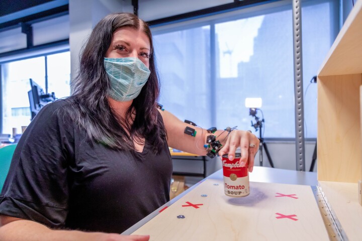 Stroke survivor Heather Rendulic demonstrates the function restored to her left arm and hand