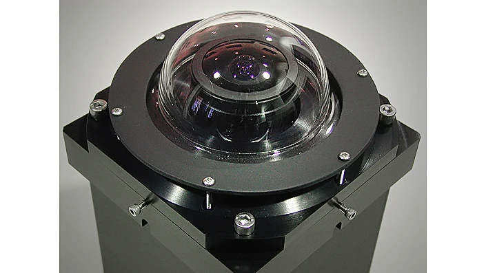 The lens mounting plate is heated to prevent moisture from forming on the lens or the dome