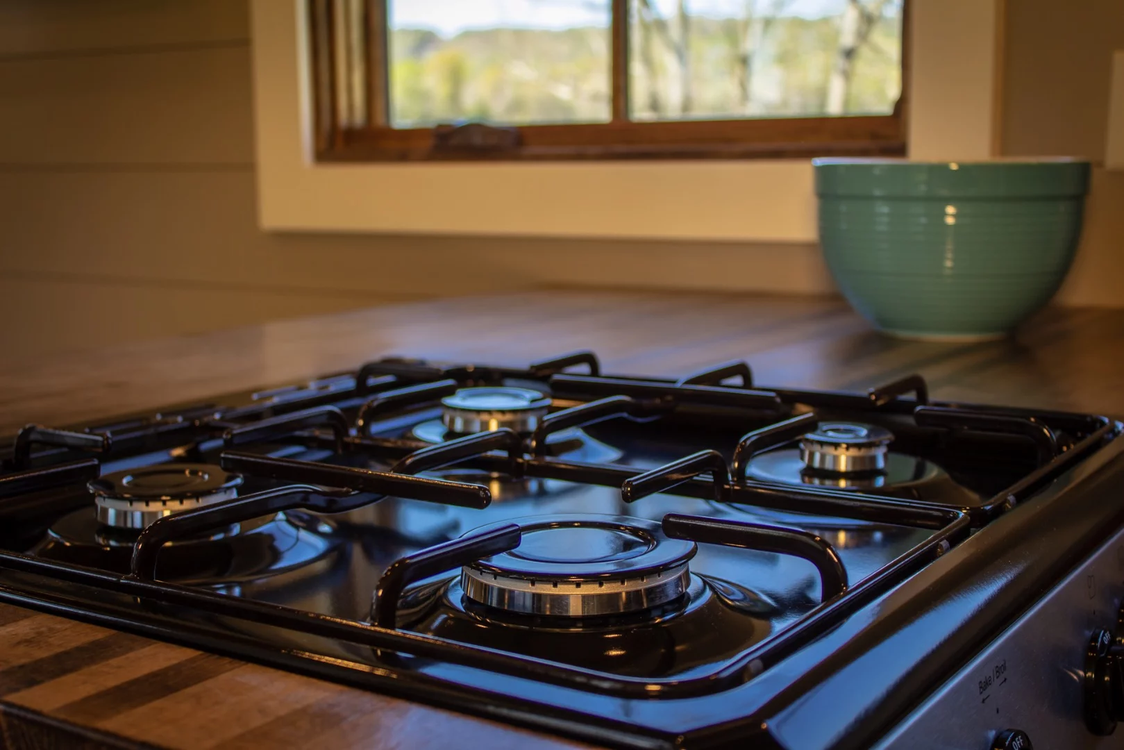 The Cedar House's kitchen includes a propane-powered cooker with four-burner stove